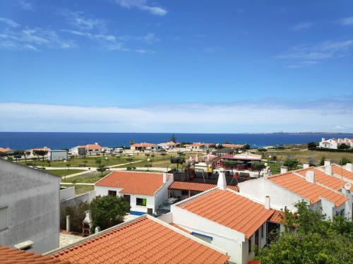 an aerial view of a town with red roofs at Apartamento Rosa in Porto Covo