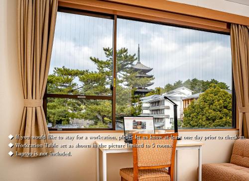a window with a view of a pagoda at NARA Visitor Center and Inn in Nara