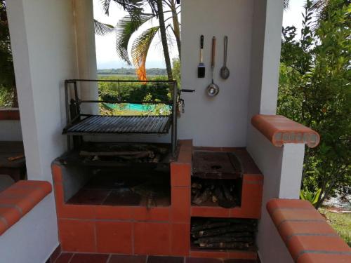 a house with a plunge pool and a patio at Finca Mirador la Giralda in Roldanillo