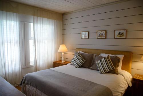 a bedroom with a large bed and a window at Pousada Boutique Itaipava in Itaipava