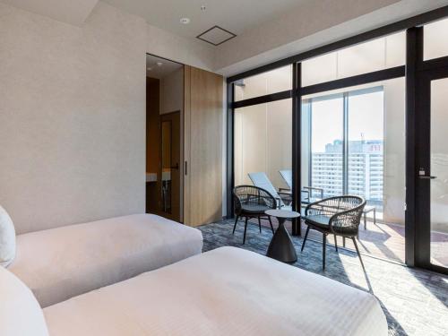 Postel nebo postele na pokoji v ubytování Akabane Holic Hotel