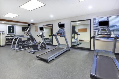 a gym with treadmills and elliptical machines at Candlewood Suites Grand Rapids Airport by IHG in Grand Rapids