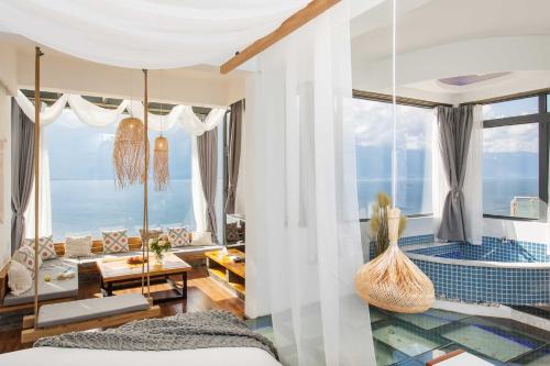 a bedroom with a view of the ocean at Aishe Honeymoon Erhai Lake Sea View Guesthouse in Dali