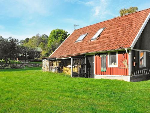 een schuur met een rood dak op een groen veld bij 6 person holiday home in ASKER N in Stenungsund