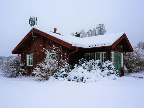 a log cabin with snow on the roof at 6 person holiday home in BODAFORS in Västrahyn