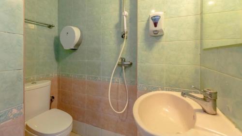 a bathroom with a shower with a sink and a toilet at Hotel Duke in Singapore