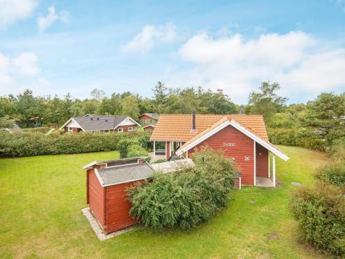a house with a red shed in a yard at 6 person holiday home in Hemmet in Hemmet