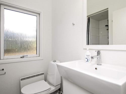 a bathroom with a sink and a toilet and a window at Six-Bedroom Holiday home in Humble in Humble