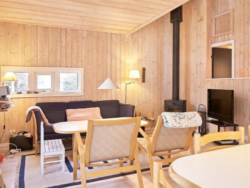 a living room with a table and a couch at 6 person holiday home in Aakirkeby in Vester Sømarken
