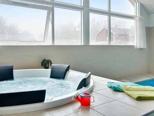 a bathtub in a room with a large window at 16 person holiday home in Tisvildeleje in Tisvildeleje