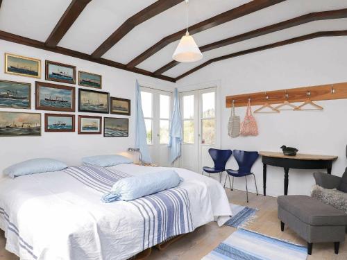 スケーエンにあるPeaceful Holiday Home in Skagen near Seaのベッドルーム1室(ベッド1台、テーブル、椅子付)