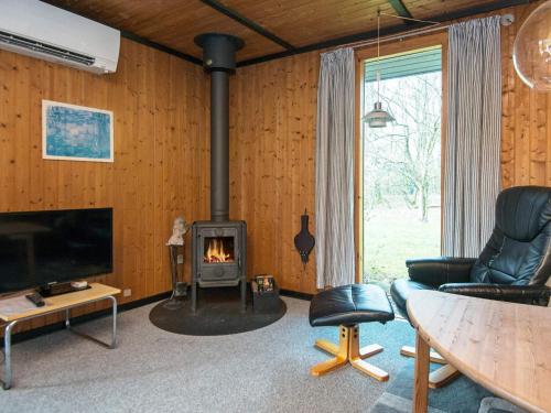a living room with a wood stove in a room at 6 person holiday home in Toftlund-By Traum in Vestergård