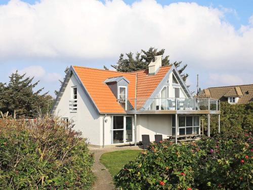 pomarańczowy dach na białym domu w obiekcie 10 person holiday home in Bl vand w mieście Blåvand