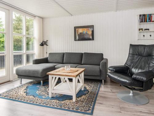 a living room with a couch and a table at 5 person holiday home in Hemmet in Falen