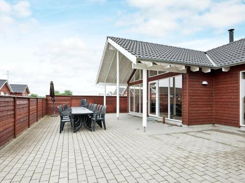 un patio con mesa, sillas y techo en 18 person holiday home in Nordborg, en Nordborg