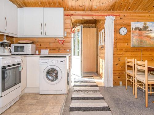 a kitchen with a washer and dryer in a cabin at 4 person holiday home in Skjern in Lem