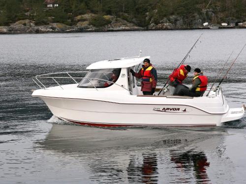 three men in a white boat on the water at Holiday Home Foreneset in Jelsa