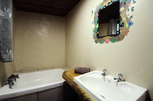 a bathroom with two sinks and a mirror on the wall at Away with the Fairies in Hogsback