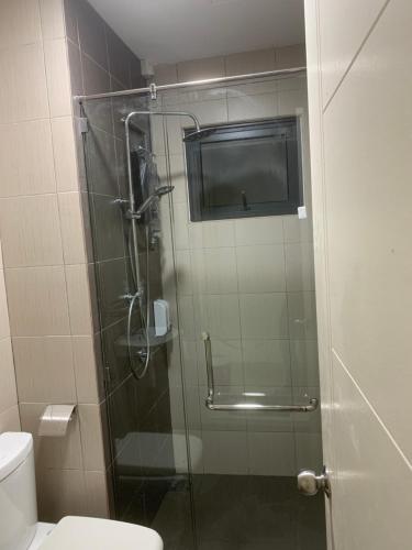 a bathroom with a glass shower with a toilet at 4A Icon Residence in Kuala Terengganu