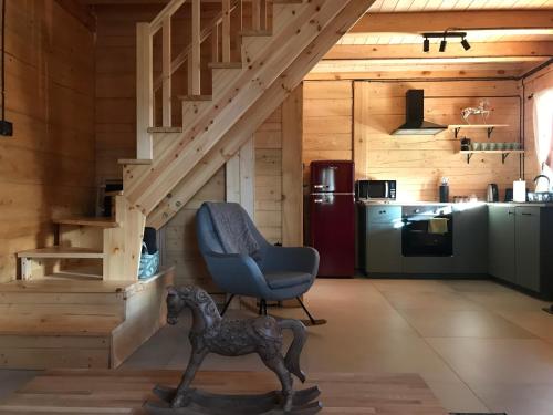 a room with a wooden staircase with a rocking horse in a house at FoRest Inn in Trzepieciny
