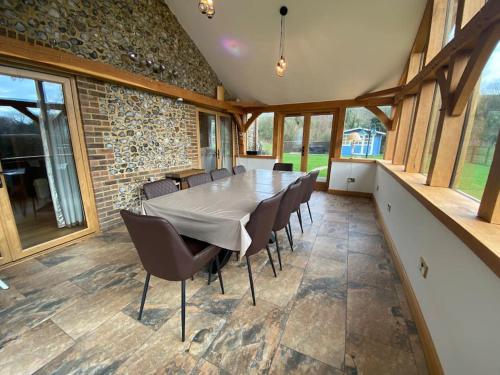 a large dining room with a table and chairs at Eco-friendly Dorset cottage with spa set in heart of countryside in Sydling St Nicholas
