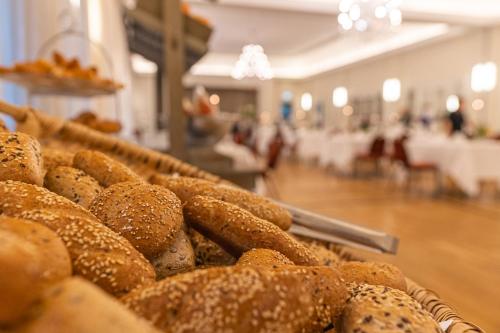 a pile of bagels on display in a bakery at Romantik Hotel Landschloss Fasanerie in Zweibrücken
