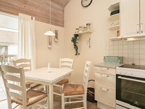 cocina con mesa y sillas en 4 person holiday home in r sk bing, en Ærøskøbing