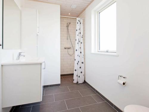 a bathroom with a shower and a sink and a window at 10 person holiday home in Rødby-By Traum in Rødby