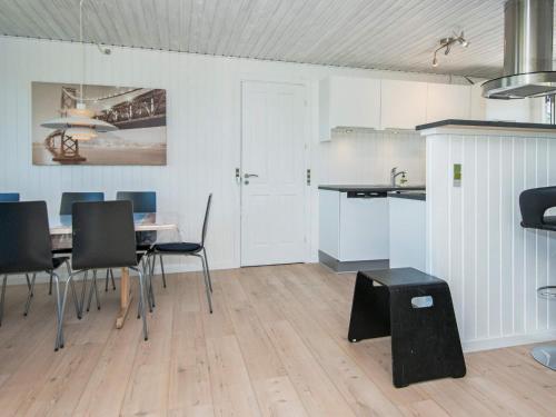 a kitchen and dining room with a table and chairs at 6 person holiday home in Allingåbro-By Traum in Rygård Strand