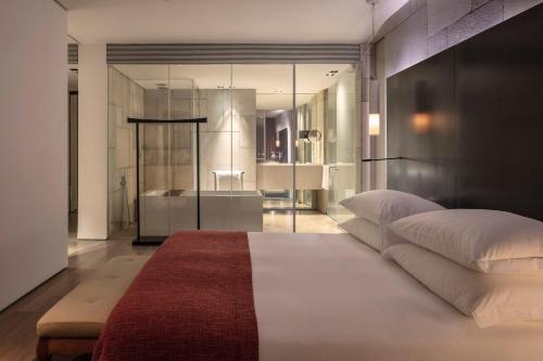 a bedroom with a large bed and a bathroom at Mamilla Hotel in Jerusalem