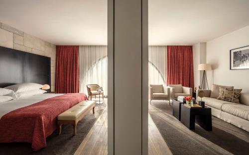 a bedroom with a bed and a living room at Mamilla Hotel in Jerusalem