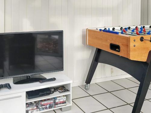 a table with a video game console and a television at 14 person holiday home in Glesborg in Glesborg