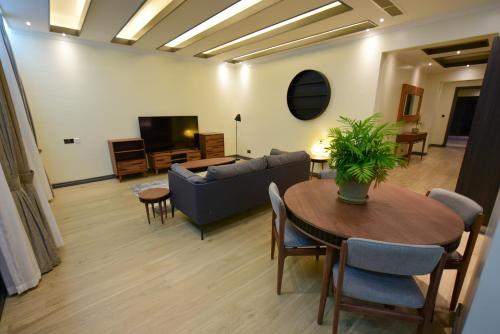 a living room with a couch and a table at Fontis Residences Hotel in Kampala