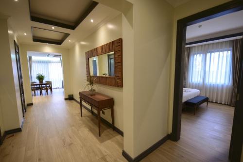 a hallway with a room with a bed and a mirror at Fontis Residences Hotel in Kampala
