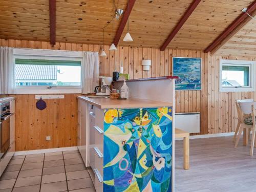 a kitchen with wooden walls and a counter top at 4 person holiday home in Hvide Sande in Bjerregård