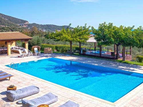 a swimming pool with blue water in a yard at Ferenity in Iraklitsa