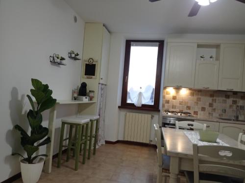 a kitchen and dining room with a table and chairs at HOUSE PIAZZA VITTORIA in Medole