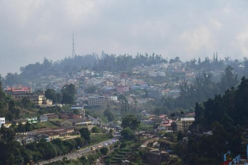 a view of a city from a mountain at B2B Home Stay in Kodaikānāl