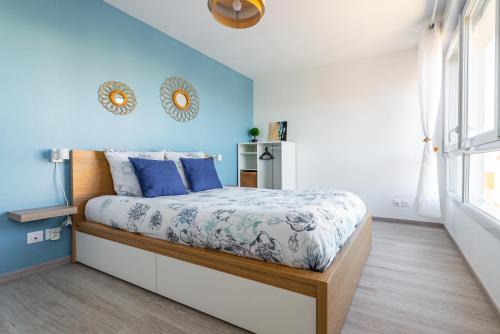 - une chambre avec un lit aux murs bleus dans l'établissement Au 4 le long du canal avec Parking, à Dijon