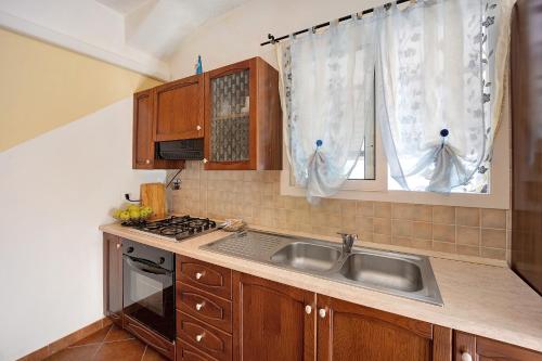 a kitchen with a sink and a stove at Le Mimose Bilo4 in Imperia