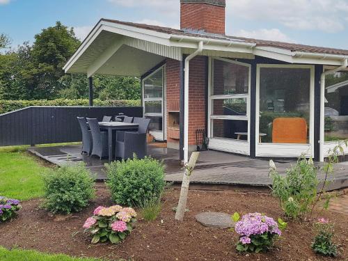 a house with a deck with chairs and a table at 6 person holiday home in Silkeborg in Silkeborg