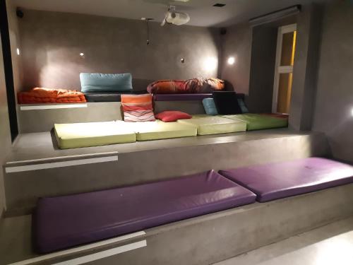 a room with a couch with several pillows on it at Safestay Madrid Central in Madrid