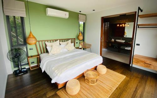 a bedroom with a large bed and a bathroom at Mirage Villa in Hinkong