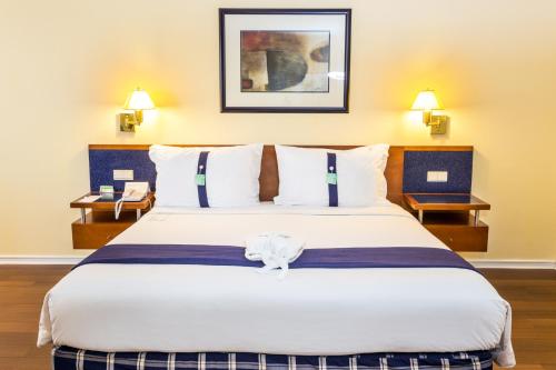 a large bed in a hotel room with two lamps at Holiday Inn Lisbon, an IHG Hotel in Lisbon