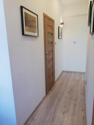 a room with a door and a wooden floor at Suwałki Centrum Apartments 1 & 2 in Suwałki