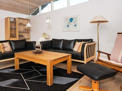 a living room with a couch and a table at 6 person holiday home in R nde in Rønde