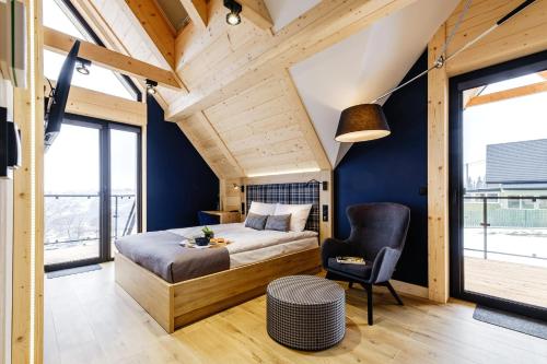 a bedroom with a bed and a chair at Bańska Ostoja in Bańska Niżna