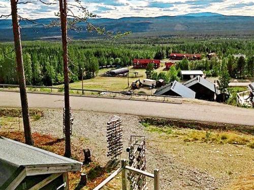 a view of a road next to a town with a farm at 8 person holiday home in VEMDALEN in Vemdalen