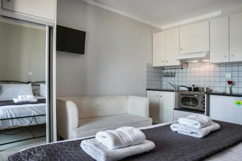 a room with a bed and towels on a table at Fidias city rooms in Argostoli