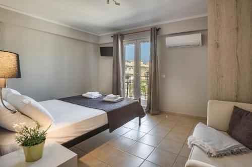 a hotel room with a bed and a couch at Fidias city rooms in Argostoli